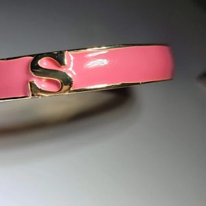 Gold tone and pink clasp bracelet with the initial "S"